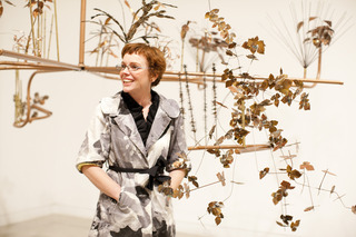 Exhibiting artist Kristi Lippire in front of her installation, Hanging Garden,Kristi Lippire