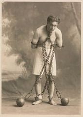 Studio photograph of Houdini in white trunks and chains,Harry Houdini