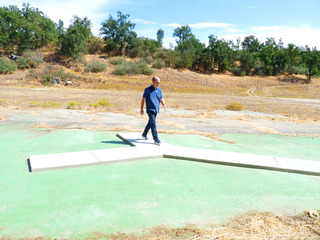 Tom McGlynn walking on his piece, "Forked Path", 2011, concrete cast in-situ on the Hatchery site of "East of Fresno",Tom McGlynn