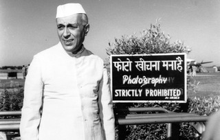  Jawaharlal Nehru caught by the camera at Palam airport while waiting for his sister, Vijayalakshmi Pandit, the Indian Ambassador in Moscow ,Homai Vyarawalla