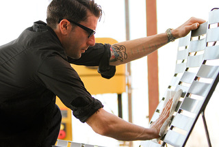 DoubleButter founder Dexter Thornton shines one of the design and manufacturing studio’s original pieces.,