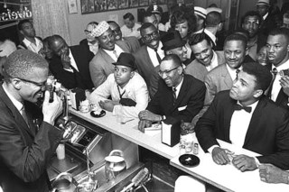 Black Muslim leader Malcolm X photographing Cassius Clay, Miami,Bob Gomel
