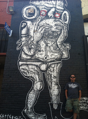 Satterugly in front of his mural in DTLA,Satterugly