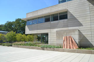 A fragment of Danh Vo’s ongoing project "We The People"--full-scale replicated pieces of the Statue of Liberty--is positioned against the University of Chicago\'s Booth Business School,Danh Vo